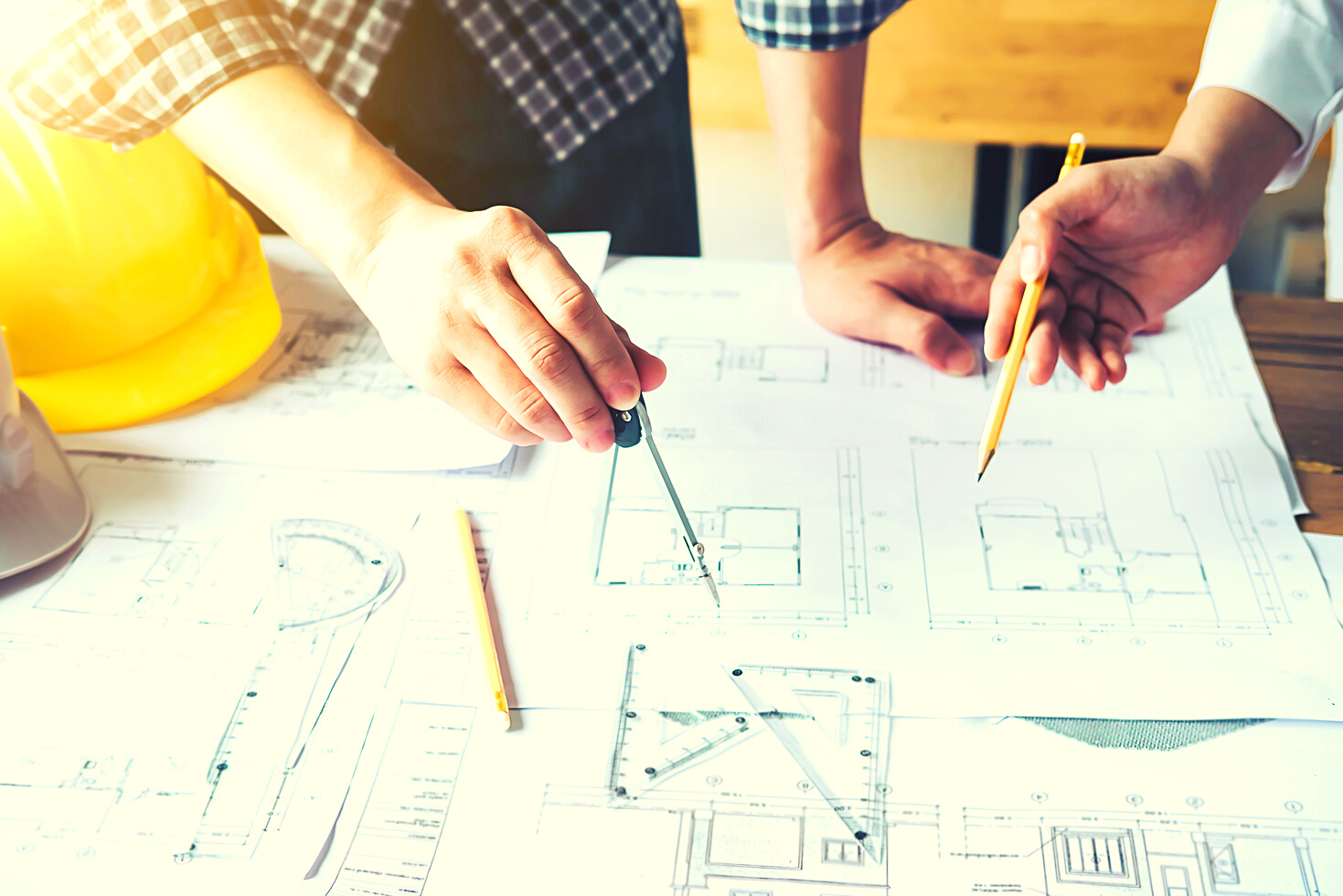 Architect Using Compass on Blueprint Construction Project